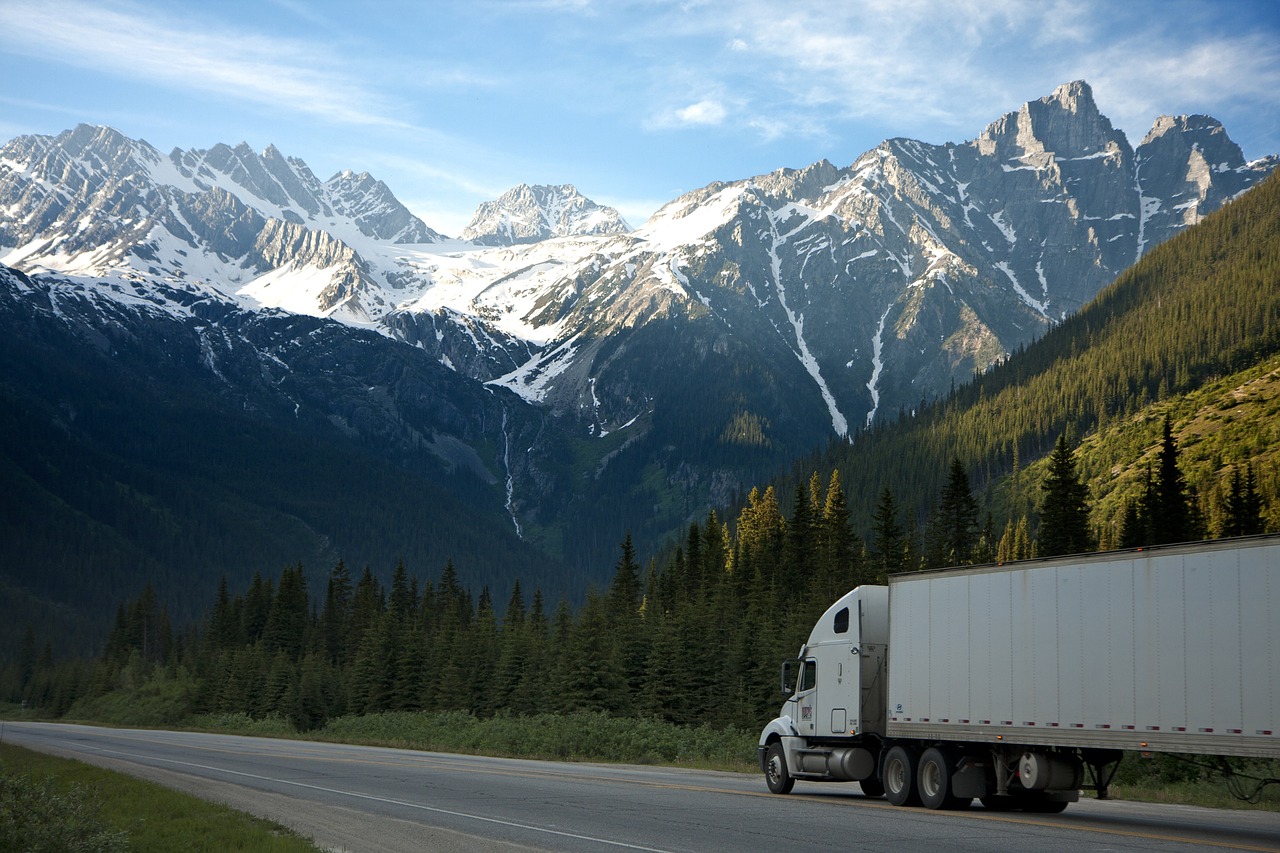 Truck in a highway with the mountains as a background