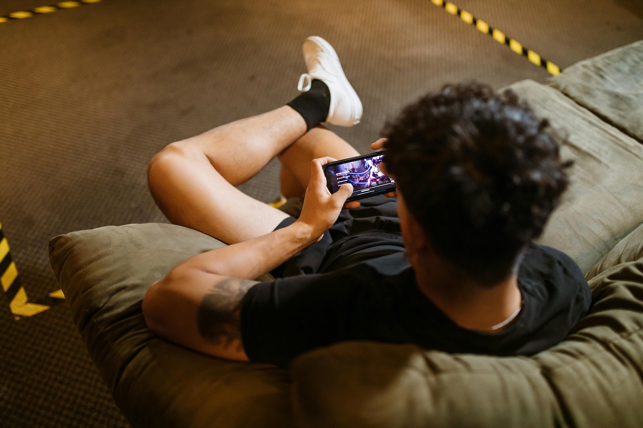 A young man playing games on his phone