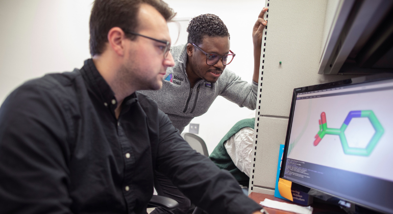 Left to Right: Ethan Grimes, BS, and Paul Morgan, MD, conduct rational drug design at the newly launched AI Small Molecule Drug Discovery Center at the Icahn School of Medicine at Mount Sinai.